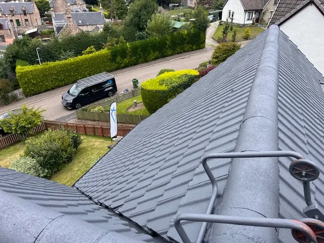 Clean grey tiled roof after professional roof coating service